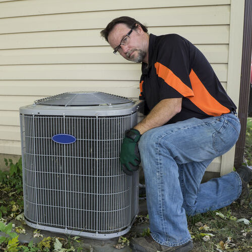 HVAC Technician Checks an Outdoor AC Unit.